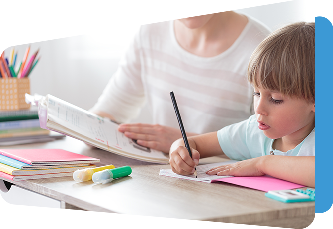 child writing in booklet with adult looking on