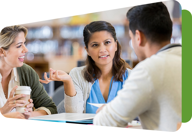 three teachers talking at a table