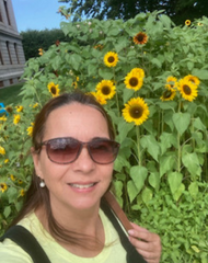 Selfie of Adriane Cioppa in front of sunflowers