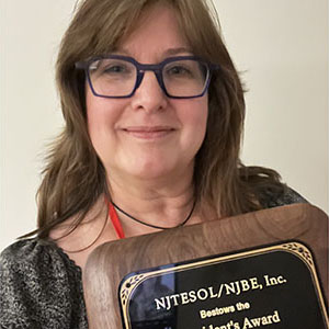 closeup of Lynn holding her award plaque