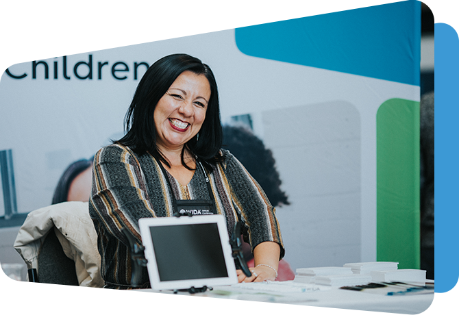 wida employee helping conference attendees at a booth