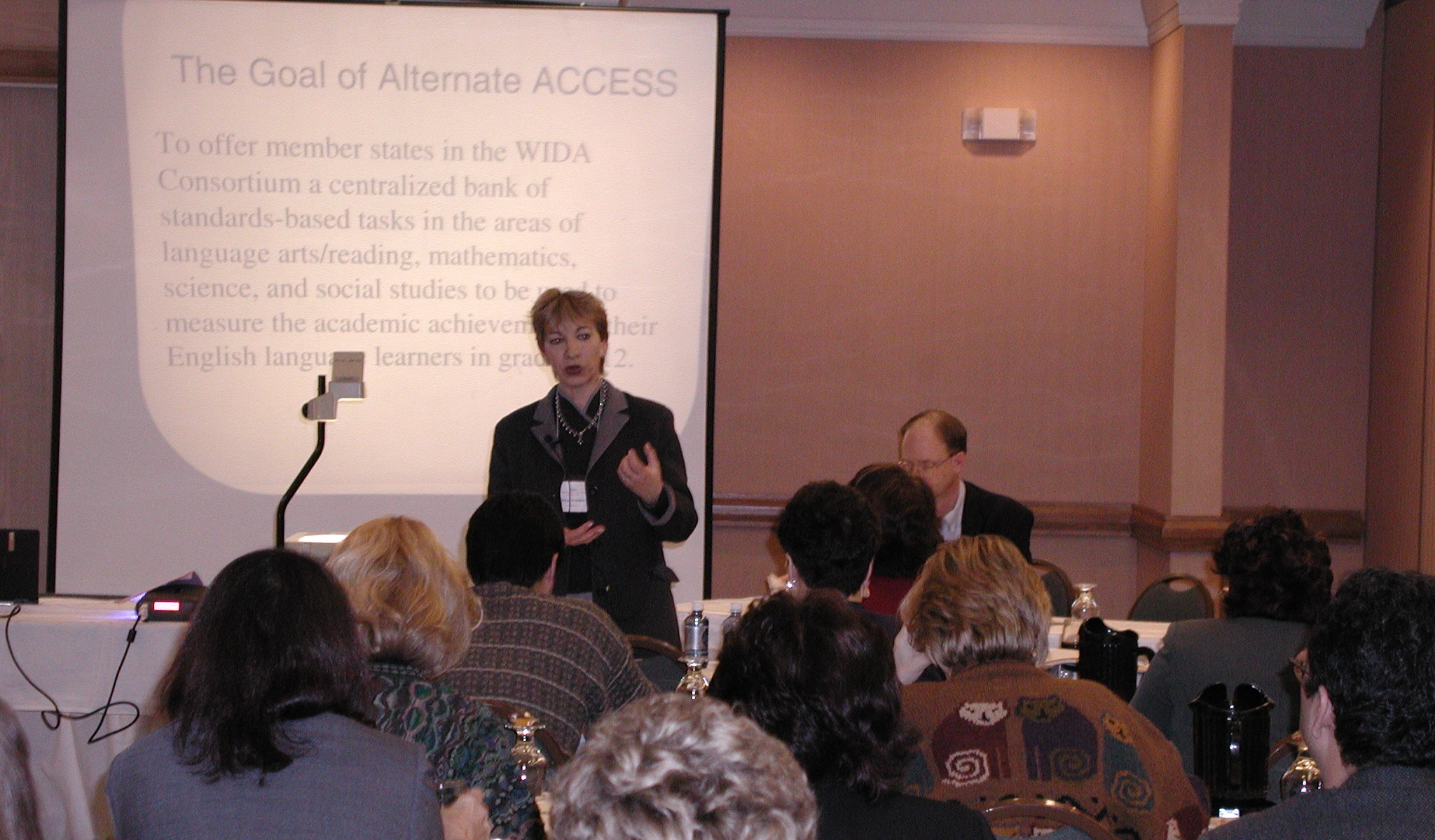 archive photo of margo gottlieb presenting to a group about WIDA using an overhead projector