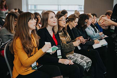 Conference attendees listening to a presenter