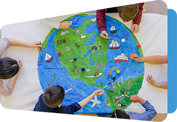 top view of children painting a globe