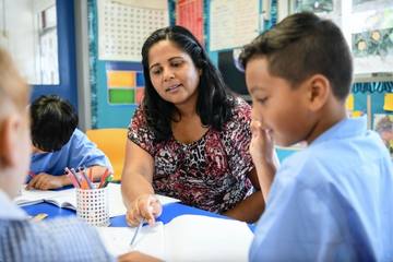 teacher working with student