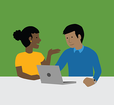 Two people sitting at a table with a laptop, having a discussion. 