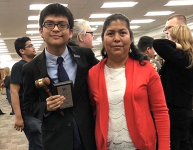 Daniel and his mom at a school event where he received an award from the debate team.