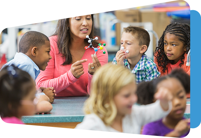 teacher showing young students a chemistry set